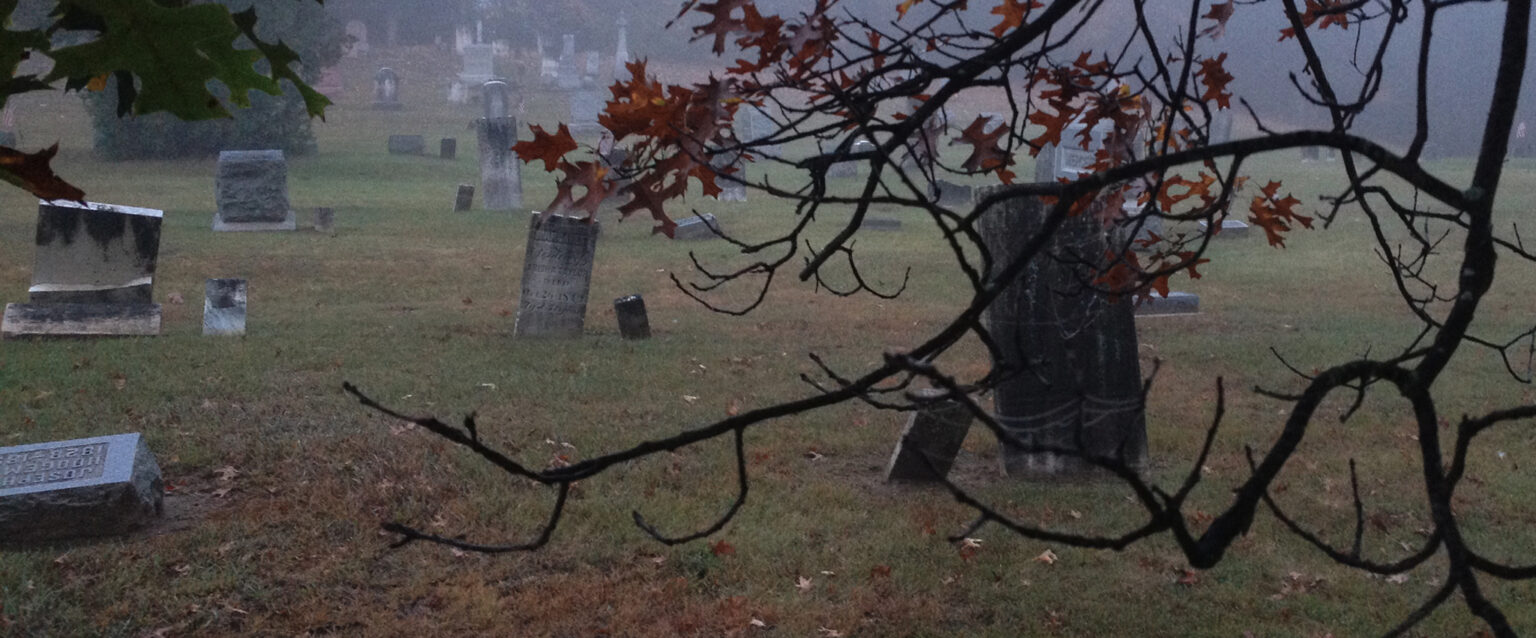 Neglected tombstones at an old graveyard in the midst of a foggy Spring morning in Southern Michigan.