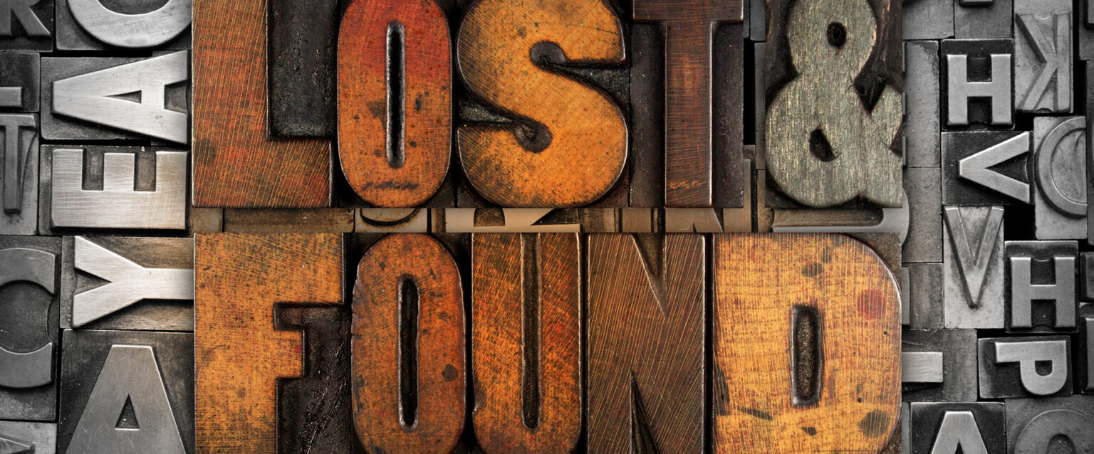 Large wooden movable-type letters that, together, spell out "Lost & Found" sit amongst a variety of metal movable-type letters.