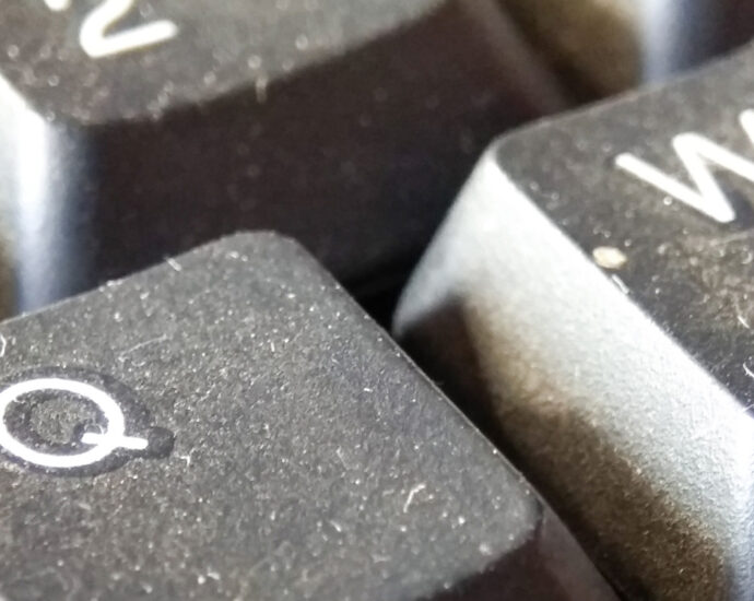 A close-up of a dust-covered, dirty computer keyboard.