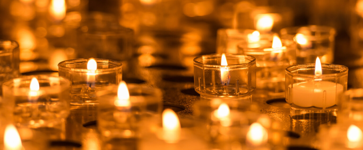 burning orange candles close up (Image: Ivan Kmit)