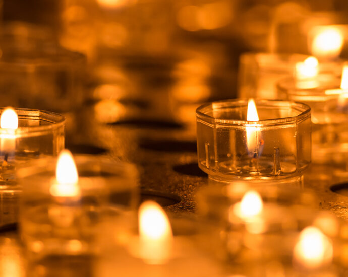 burning orange candles close up (Image: Ivan Kmit)