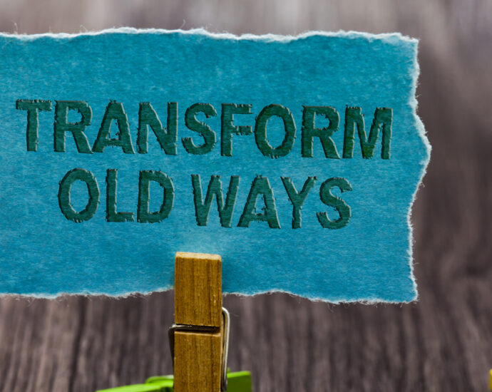A blue scrap of paper held in a clothespin says Transform Old Ways (Image: Artur Szczybylo)