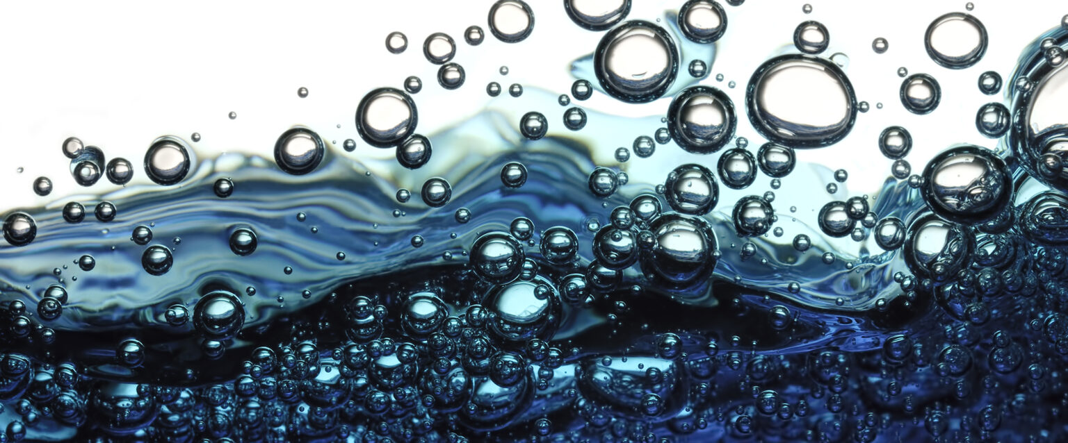 Surface bubbles in blue water.
