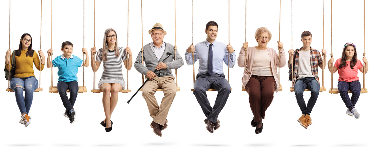Children, young people, and seniors—8 in all—sit on swings and smile.