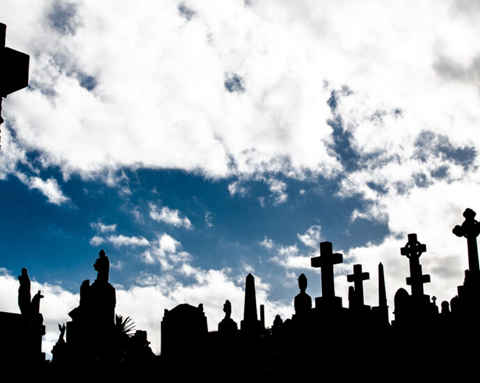 A Silhouette of graveyard, the image shows many cross tombstone with dramatic cloudy sky.