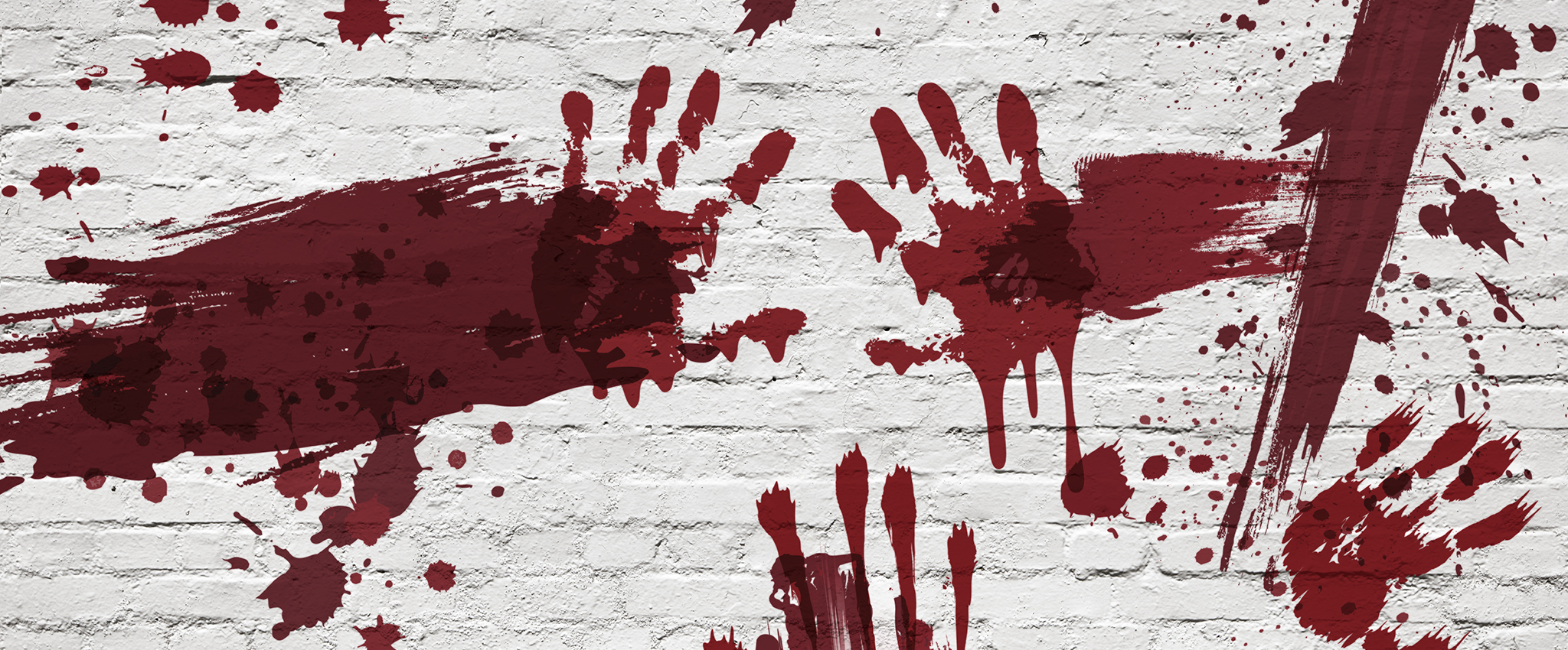 A white, painted brick wall, with handprints, smears, and splatters of red across it.