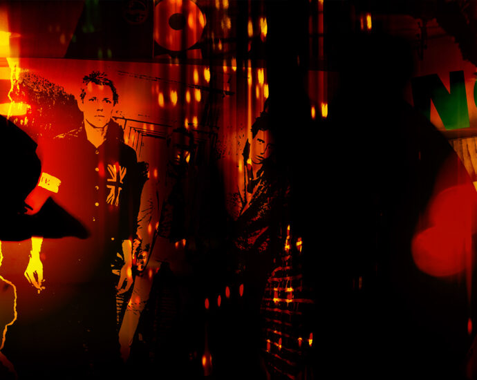 A photo composite of vintage punk vinyl album sleeves from the late 1970s and early 1980s, including Ramones, The Clash, Sex Pistols, The Fall, Savage Republic, and Dead Kennedys. The overlayed image contains the silhouette of a spike-haired punk rocker jumping with one leg in front and the other bent backward at the knee. Overall the finished piece is red, orange, yellow, and black with elements that obscure the LP art behind it.