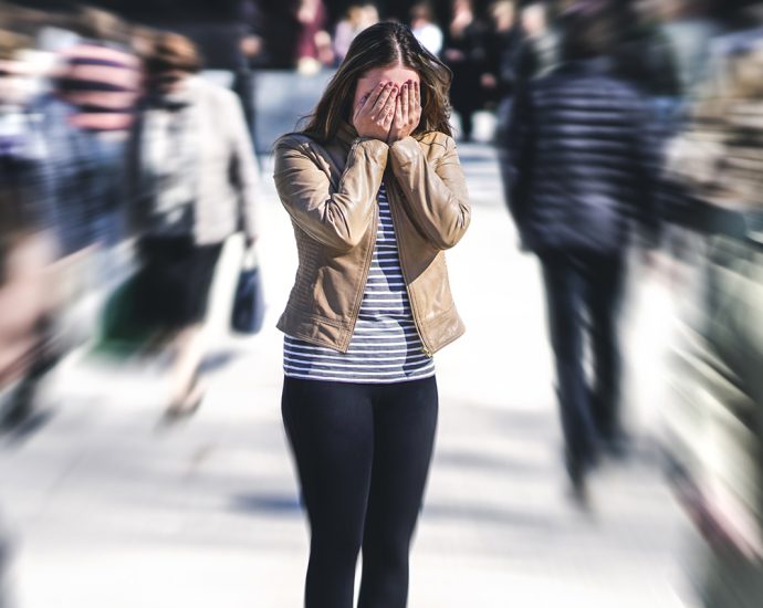 Panic attack in public place. Woman having panic disorder in cit