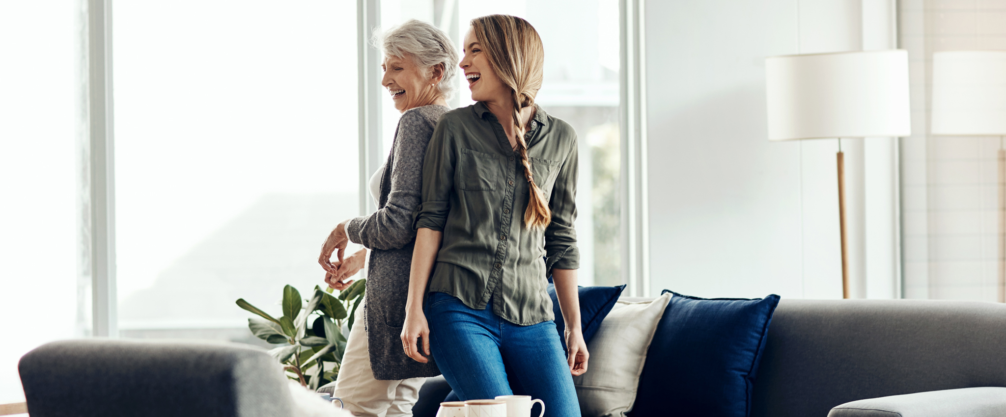She knows just how to cheer me up. a senior woman and her adult daughter dancing together at home.